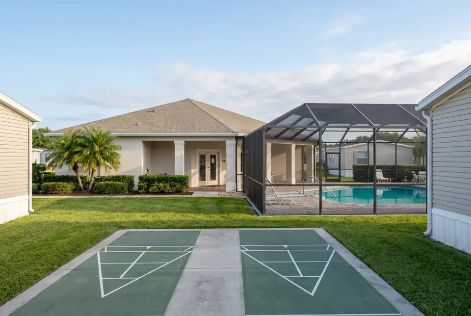 The clubhouse, pool and shuffleboard courts of a manufactured home community